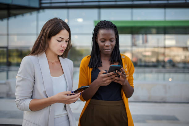 istock Businesswomen texting on the phone 1256875845
