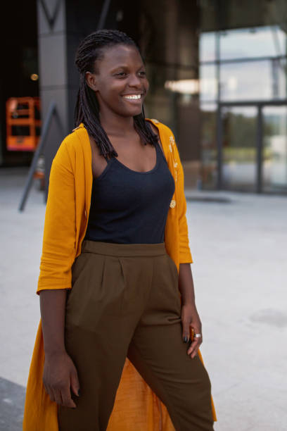 istock Happy black woman smiling outside office building 1256876069
