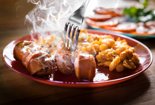 Roasted sausage with beans on a plate.