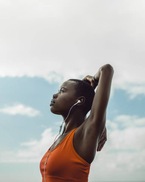 istock Female in sportswear doing arms stretches 1256877547