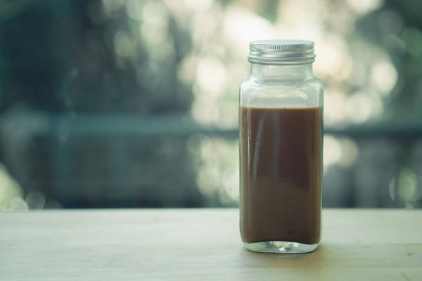 istock Coffee mocha in glass bottle on wood table 1256878368