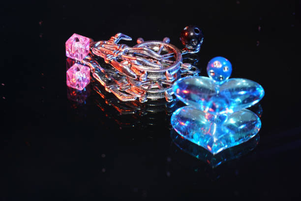istock Colorful glass beads on mirrored surface photographed in studio 1256878413
