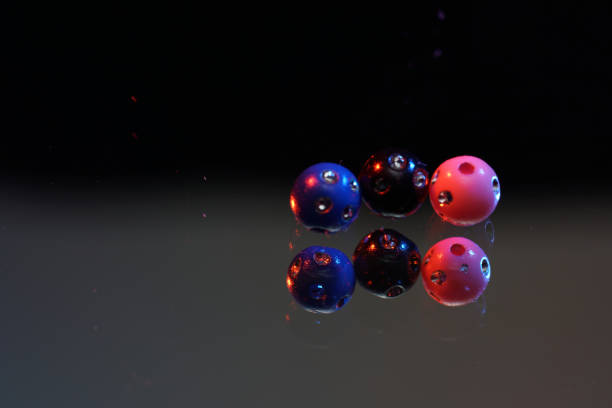 istock Colorful glass beads on mirrored surface photographed in studio 1256878429