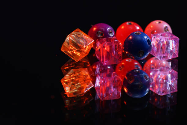 istock Colorful glass beads on mirrored surface photographed in studio 1256878514