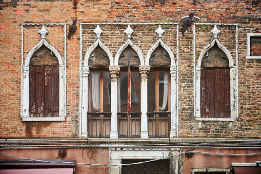 Mullioned windows on a old residential building in Murano Island. Venezia. Veneto. Italy.