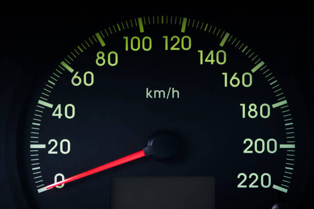 Close-Up of a Glowing black car Speedometer with a red arrow indicating 0 stock photo