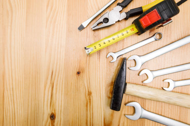 A set of tools on a wooden table top with space for text stock photo
