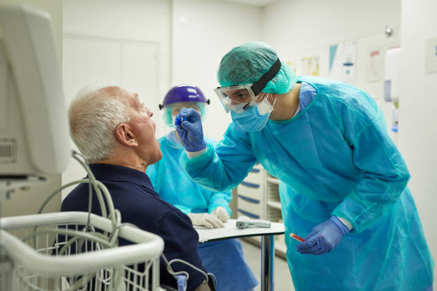 istock Healthcare Worker Taking Throat Swab for Antigen Testing 1256886009
