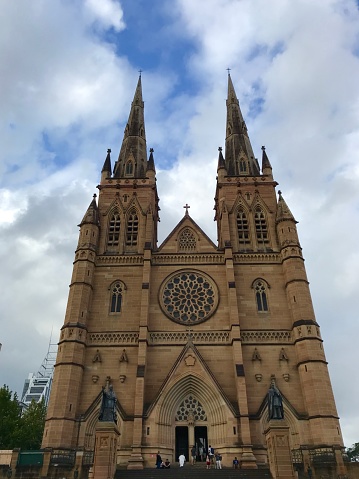 January 3, 2018 - Sydney, Australia: General view of St. Mary's Cathedral, people walking inside in a sunny summer day.\n\nThe Cathedral Church and Minor Basilica of the Immaculate Mother of God, Help of Christians is the cathedral church of the Roman Catholic Archdiocese of Sydney, designed by William Wardell and built from 1866 to 1928.