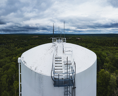 Aerial drone view of a town's water storage tank.