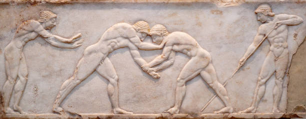 Scene wrom Palaestra Ancient bas-relief on ancient Greek funerary stele from Kerameikos in Athens, Greece Ancient bas-relief on ancient Greek funerary stele from Kerameikos in Athens, Greece. Scene from Palaestra - wrestlers in action. On the left an athlete is ready to jump, on the right another one prepairing the pit. ancient greece stock pictures, royalty-free photos & images