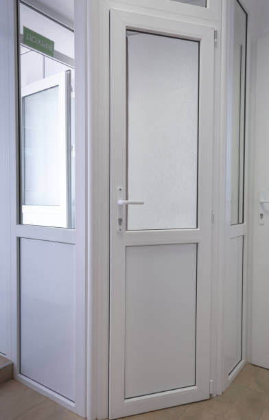 istock White pvc doors and a green sign with the inscription Exit. 1256894787