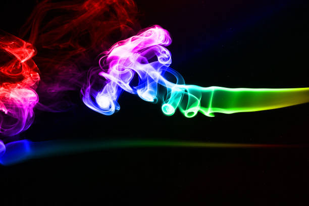 Abstract multi colored smoke on a black background stock photo