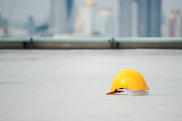 istock Yellow safety helmet on the floor at the construction site 1256896882