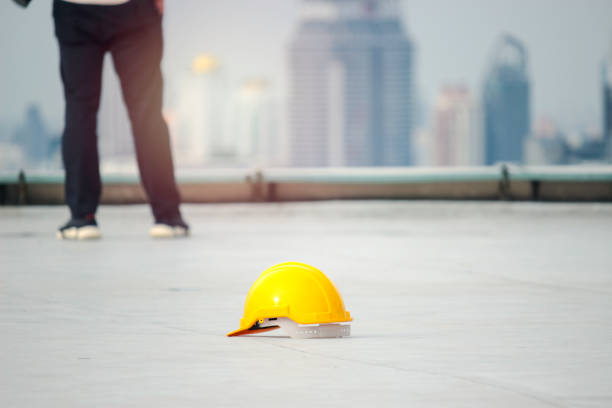 istock Yellow safety helmet on the floor at the construction site 1256896891