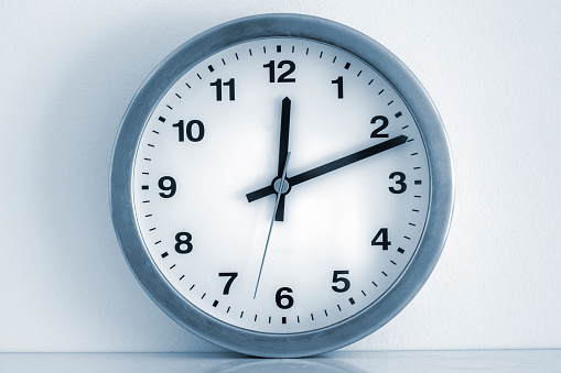 White clock isolate on the whie background. Time and work management concept.