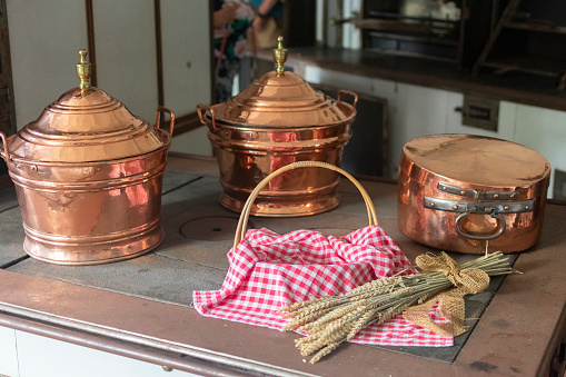 antique copper cookware on the stove