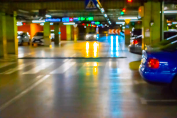 istock Parking garage blurred. Empty road asphalt background in soft focus. Car lot parking space in underground city garage. Modern underground parking. 1256899333
