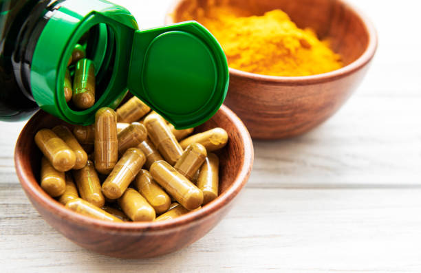 istock Turmeric powder and capsules 1256900412