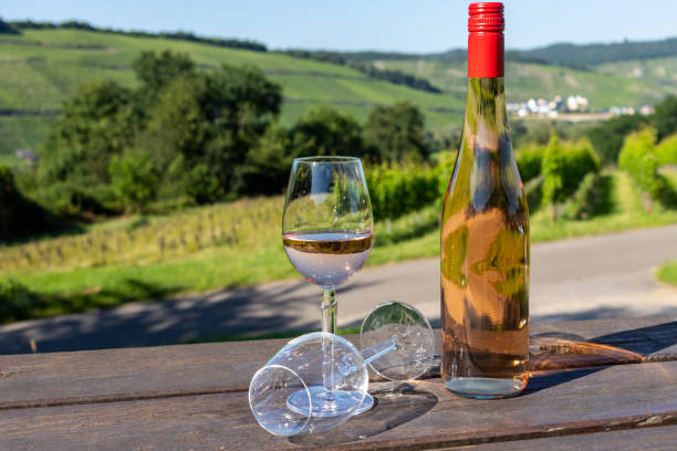 istock Wine bottle with glasses on wooden table 1256900496