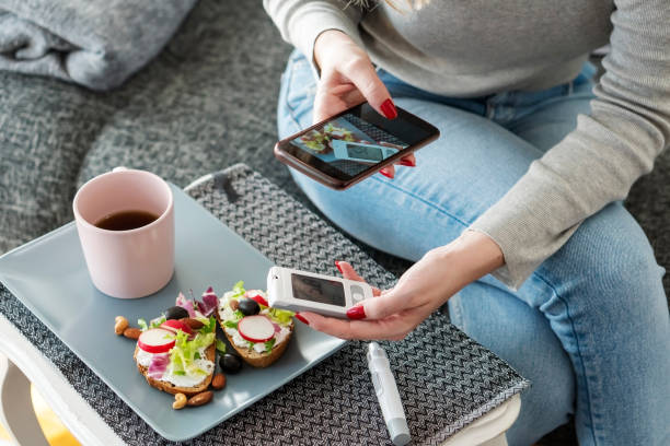 Mid adult diabetic woman having breakfast at home stock photo