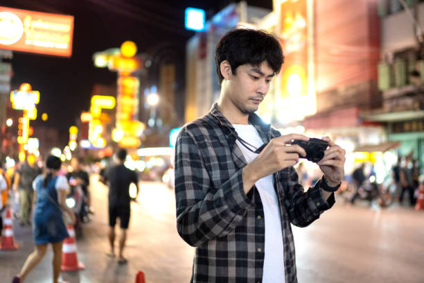 istock traveler man using digital compact camera. Journey trip lifestyle. 1256905055