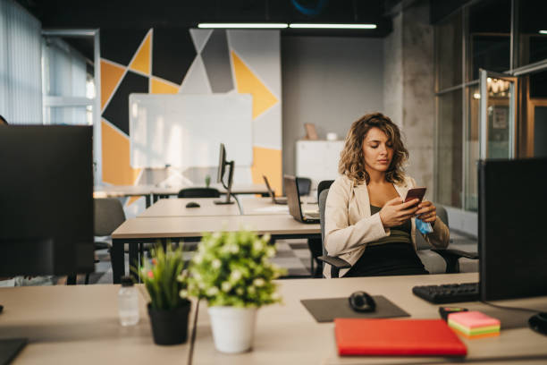 istock Young businesswoman using a cellphone in an office 1256906039