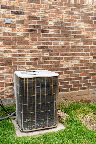 istock Air Conditioner system next to brick home. 1256906269