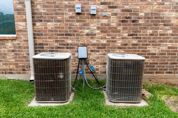 istock Older HVAC air conditioner units next to brick home with copy space 1256906321