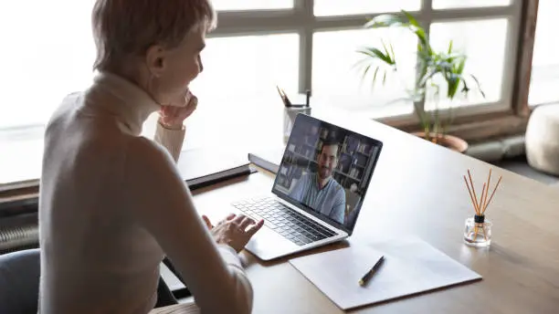 Photo of Businesswoman listening applicant during distant job interview by video call