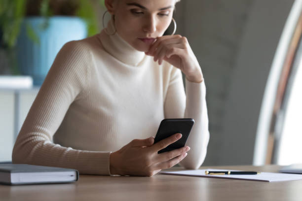 istock Businesswoman holding gadget feels concerned received unpleasant e-mail 1256907141