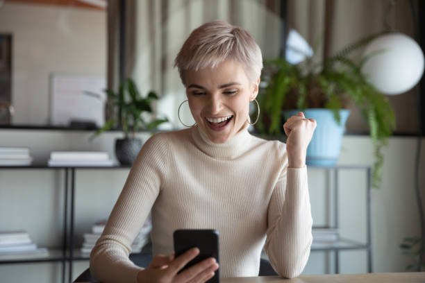 istock Employee holding smartphone use e-bank app check balance feels happy 1256907143