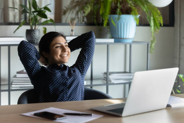 istock Indian employee resting leaned on office chair looking in distance 1256907207