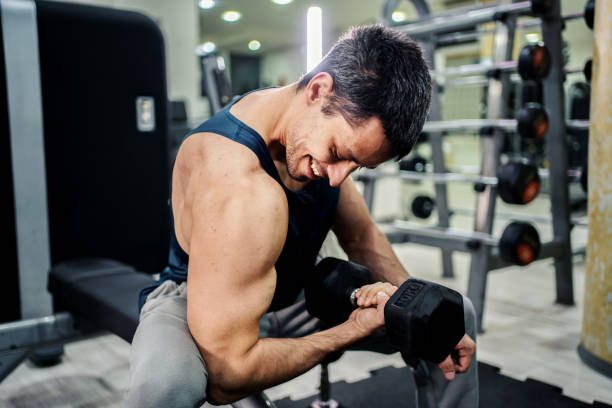 istock Strong man lifting weight at gym 1256910588
