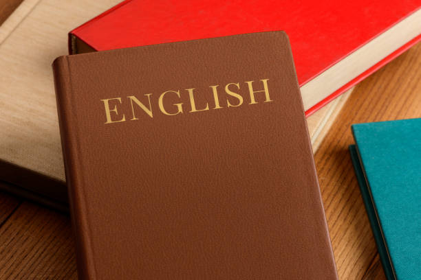 istock Pile of books on table. Learning English with grammar book 1256910603