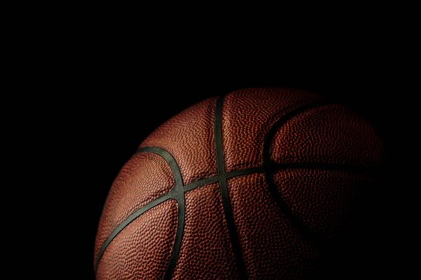 istock Composite Leather Basketball Isolated On Black Background With Spotlight, Room For Text 1256910832