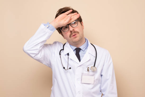istock Young caucasian man doctor looking tired after work. 1256911070