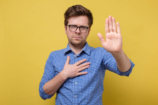 istock Man makes swearing sign with his hand open and up 1256911891