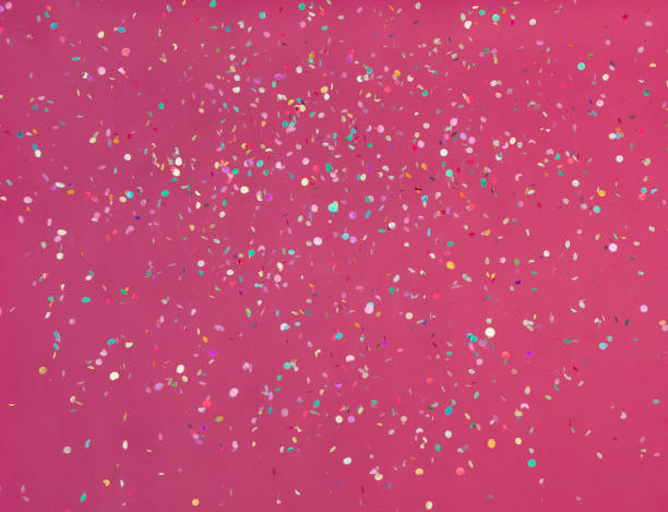 istock Pink background with colorful falling confetti 1256912215