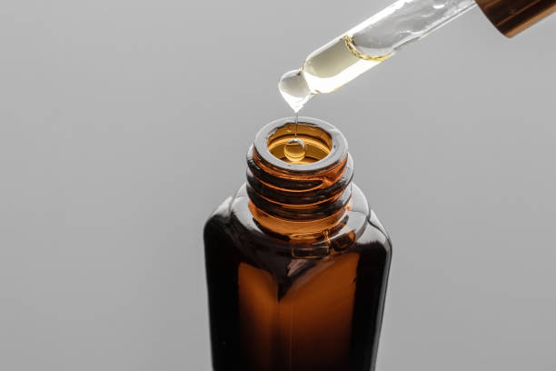 istock A drop of essential oil falling into a bottle 1256913329