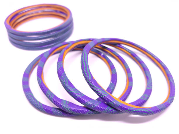 istock Multicolored Bangles on black background. Bangles are traditionally rigid bracelets, originating from the Indian subcontinent. 1256913439