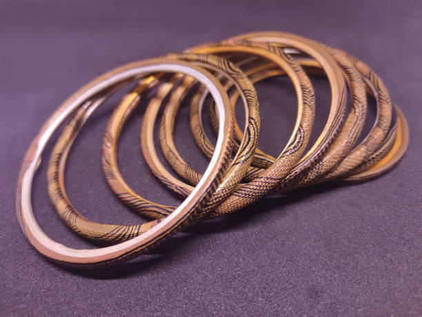 istock Multicolored Bangles on black background. Bangles are traditionally rigid bracelets, originating from the Indian subcontinent. 1256913442