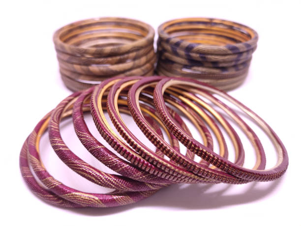 istock Multicolored Bangles on black background. Bangles are traditionally rigid bracelets, originating from the Indian subcontinent. 1256913459