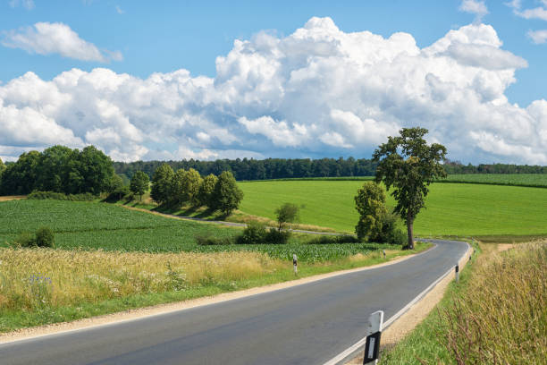 Impressive sky with cumulus clouds over a rural landscape Impressive sky with cumulus clouds over a rural landscape with an asphalt road.
Germany, Hessen near Kirtorf horizon over land stock pictures, royalty-free photos & images