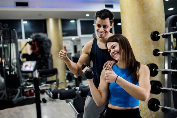 istock Young couple working out at the gym 1256914145