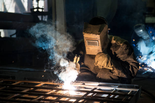 istock Closeup worker in a mask doing the welding in a workshop 1256915196