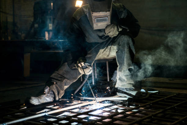 istock Closeup worker in a mask doing the welding in a workshop 1256916818