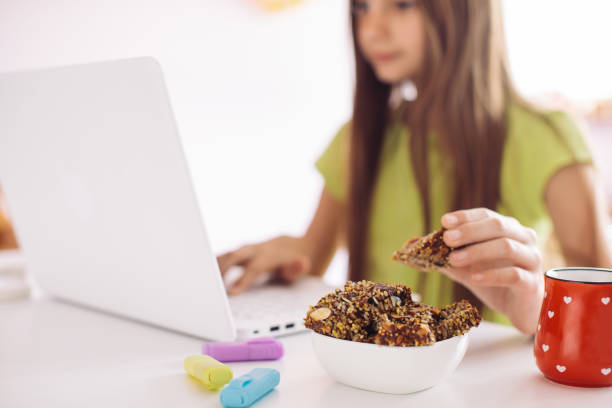istock Girl studying and doing homework on laptop at home 1256917720