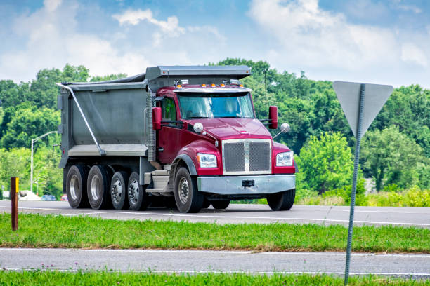 Large Dump Truck Delivering Gravel To Commercial Construction Site stock photo
