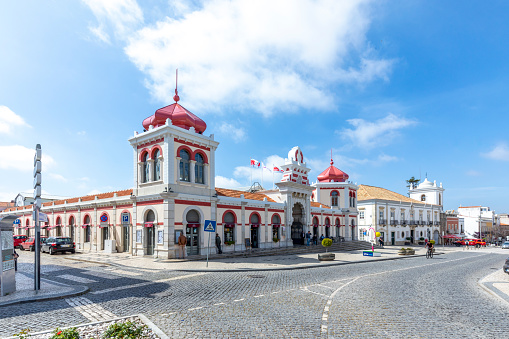 Loule, Portugal - March 13, 2020:  Moorish architectural facade of the traditional market consisting of family run stalls selling local grown or sourced produce which include fish, fabrics and gifts.